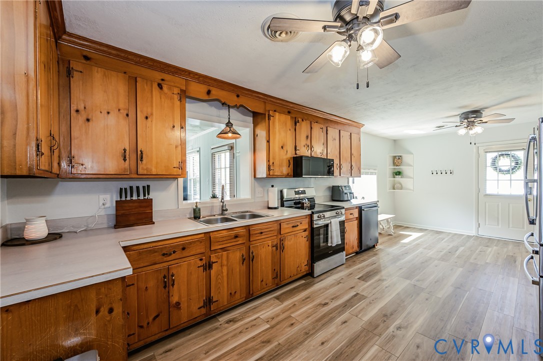 1927 F Street West Point, VA 23181 - Photo 13 of 59 a large kitchen with stainless steel appliances granite countertop a lot of counter space and wooden floors