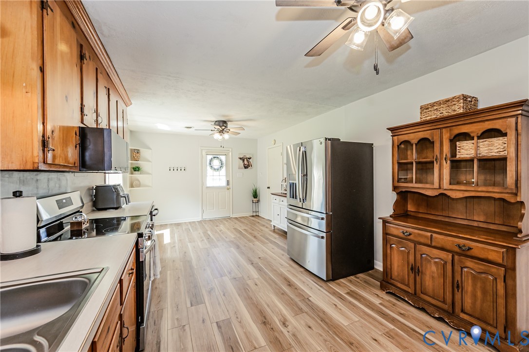 1927 F Street West Point, VA 23181 - Photo 15 of 59 a kitchen with stainless steel appliances granite countertop a refrigerator a stove top oven a sink dishwasher and wooden cabinets