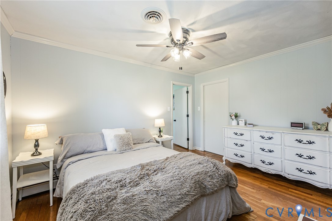 1927 F Street West Point, VA 23181 - Photo 26 of 59 a bedroom with a bed and a chandelier