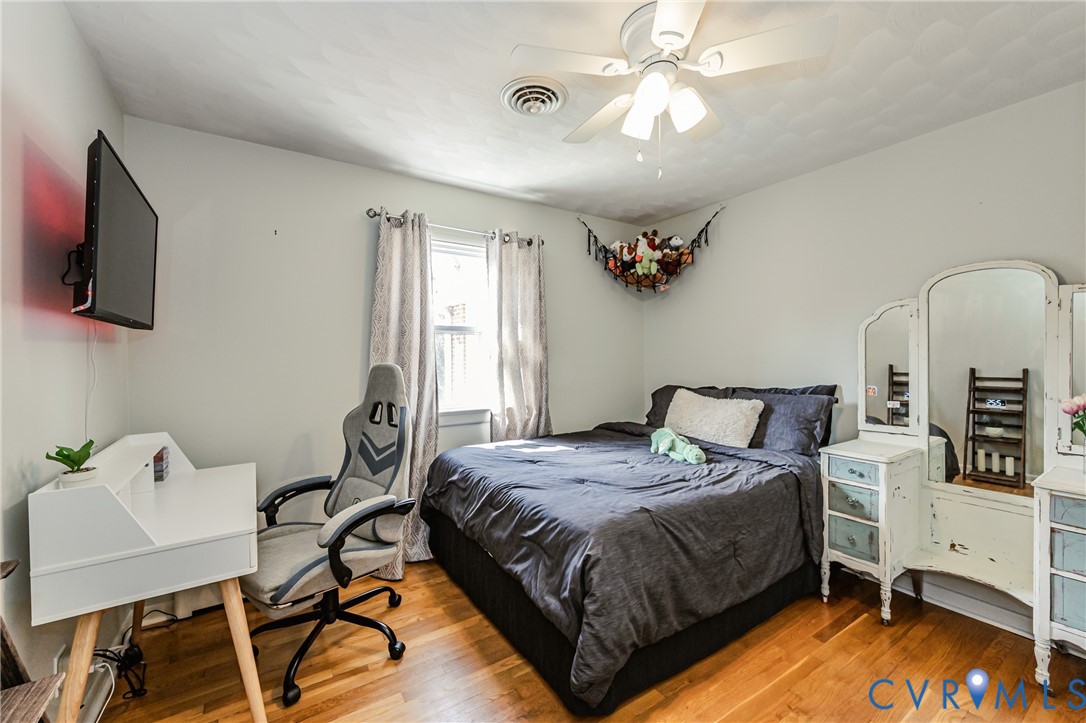 1927 F Street West Point, VA 23181 - Photo 31 of 59 a bedroom with a bed and a chandelier