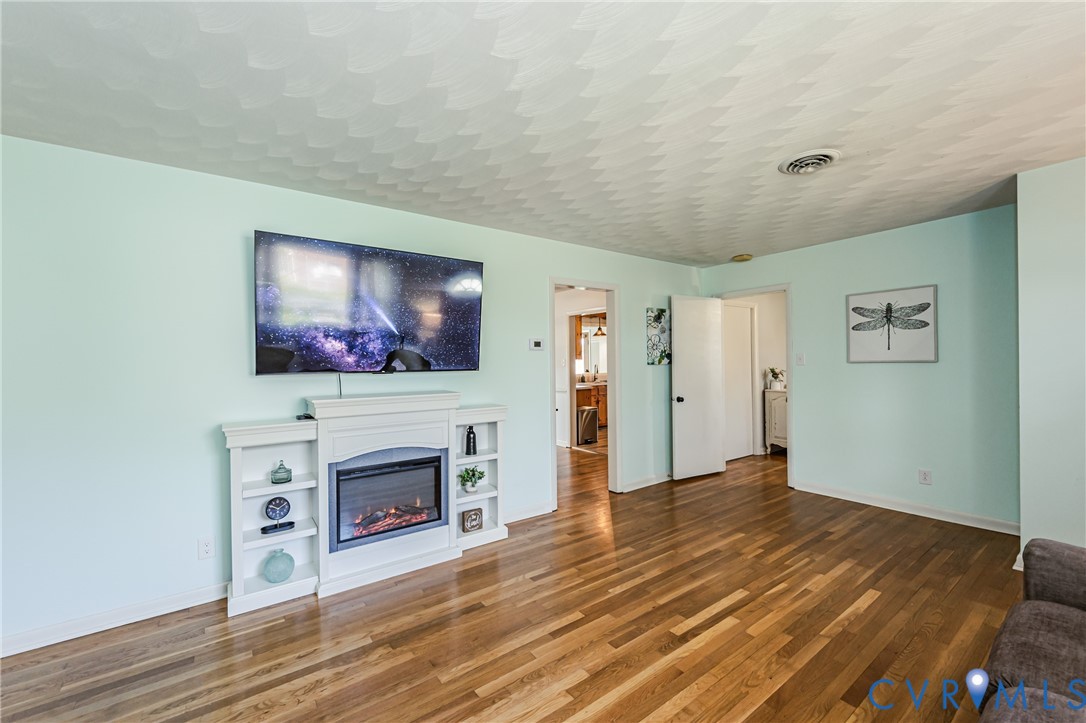 1927 F Street West Point, VA 23181 - Photo 8 of 59 a living room with furniture a flat screen tv and a fireplace