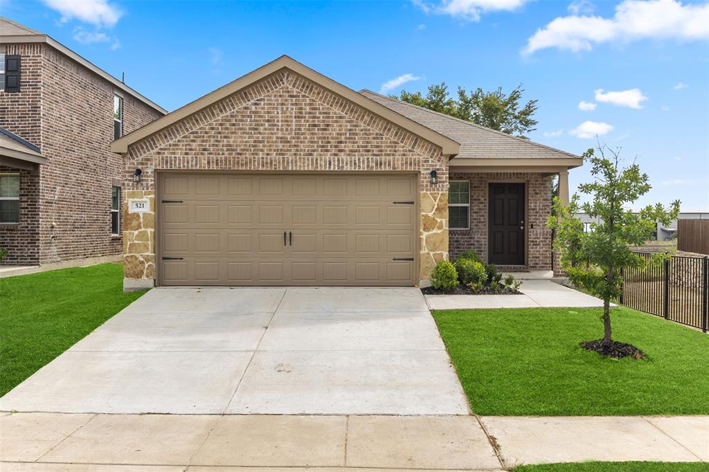 View of front facade with brick siding, an attached garage, driveway, and a shingled roof