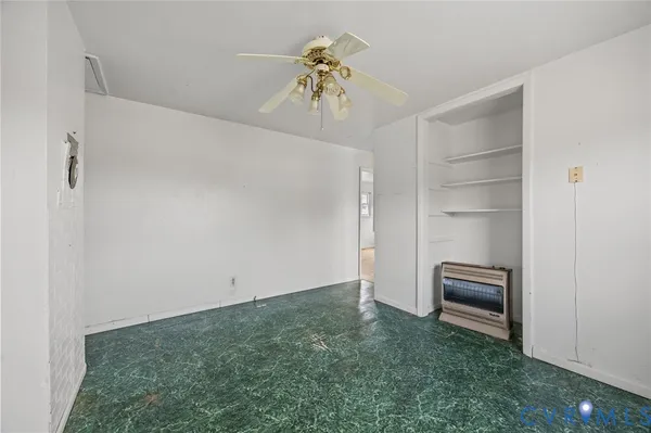 a view of room with staircase and a ceiling fan
