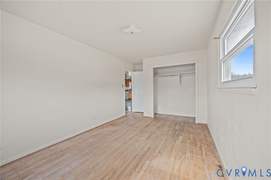 10187 Birch Island Road Wakefield, VA 23888 - Photo 31 of 41 a view of an empty room with wooden floor and a window