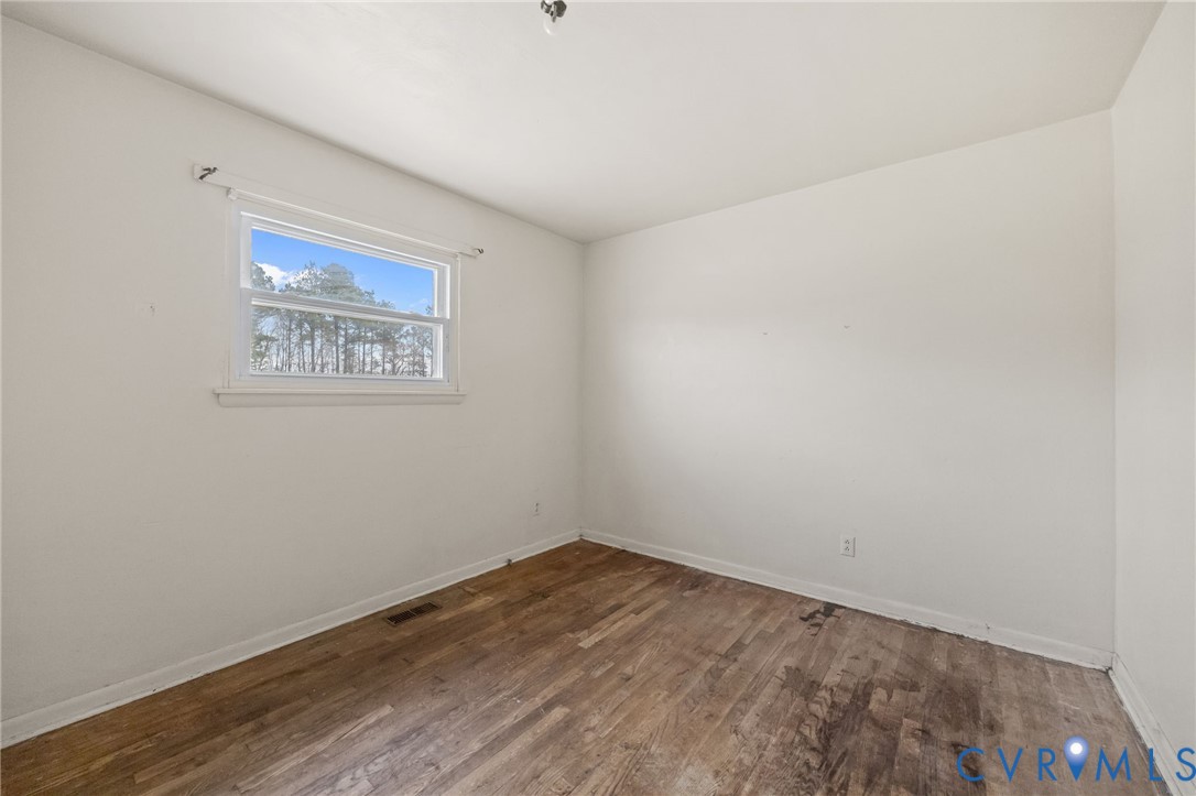 10187 Birch Island Road Wakefield, VA 23888 - Photo 33 of 41 a view of an empty room with wooden floor