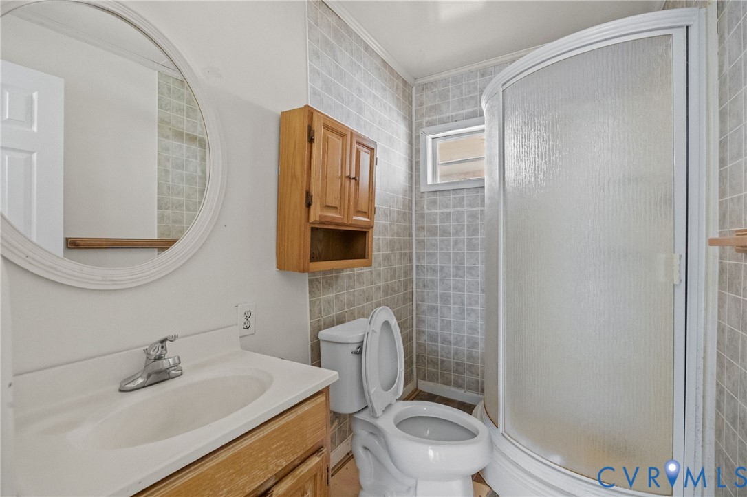 10187 Birch Island Road Wakefield, VA 23888 - Photo 36 of 41 a bathroom with a sink a toilet and shower