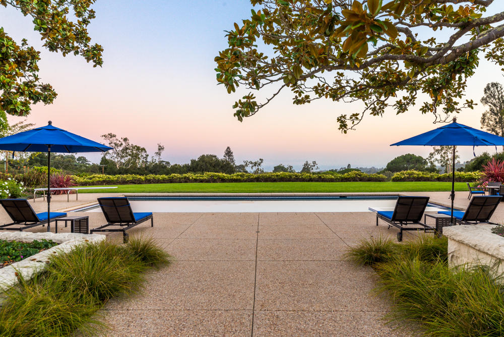 881 San Ysidro Lane Montecito, CA 93108 - Photo 14 of 78 a view of a swimming pool with lawn chairs under an umbrella