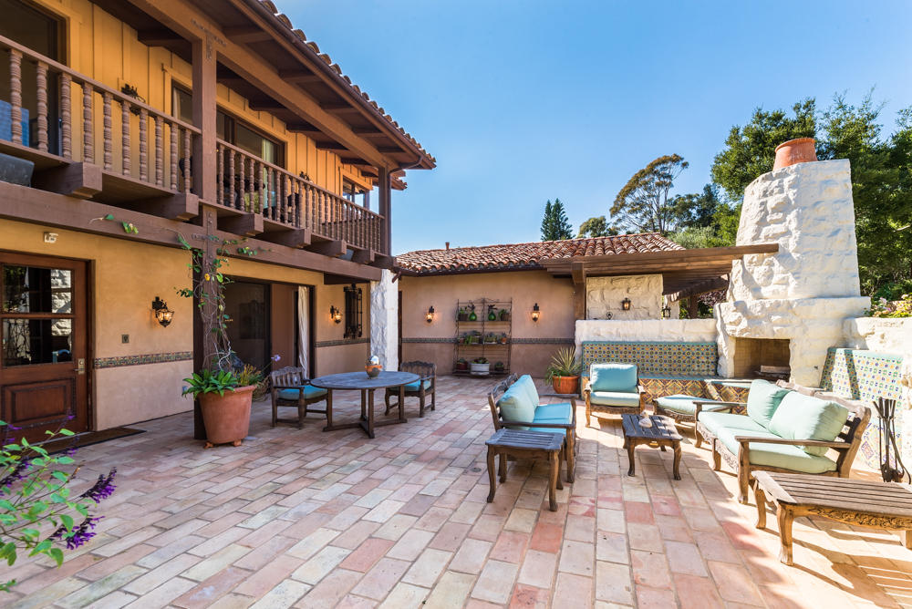881 San Ysidro Lane Montecito, CA 93108 - Photo 26 of 78 a view of a patio with dining table and chairs and potted plants