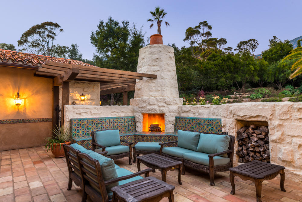 881 San Ysidro Lane Montecito, CA 93108 - Photo 28 of 78 an outdoor living area with furniture and a fireplace