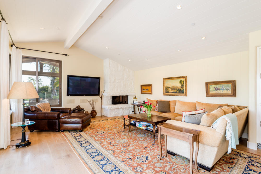 881 San Ysidro Lane Montecito, CA 93108 - Photo 33 of 78 a living room with furniture a flat screen tv and a table