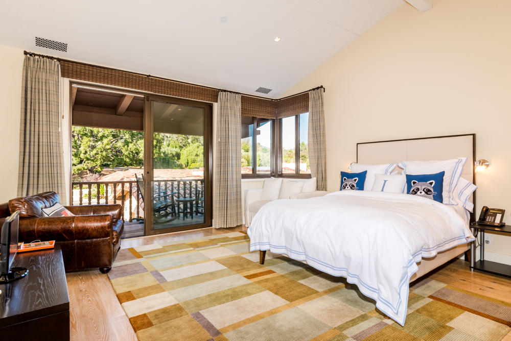 881 San Ysidro Lane Montecito, CA 93108 - Photo 42 of 78 a bedroom with a bed and glass window