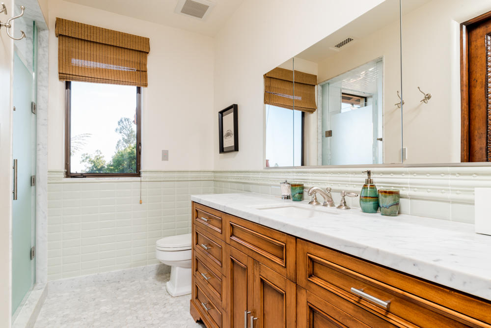 881 San Ysidro Lane Montecito, CA 93108 - Photo 43 of 78 a bathroom with a granite countertop sink mirror and a toilet
