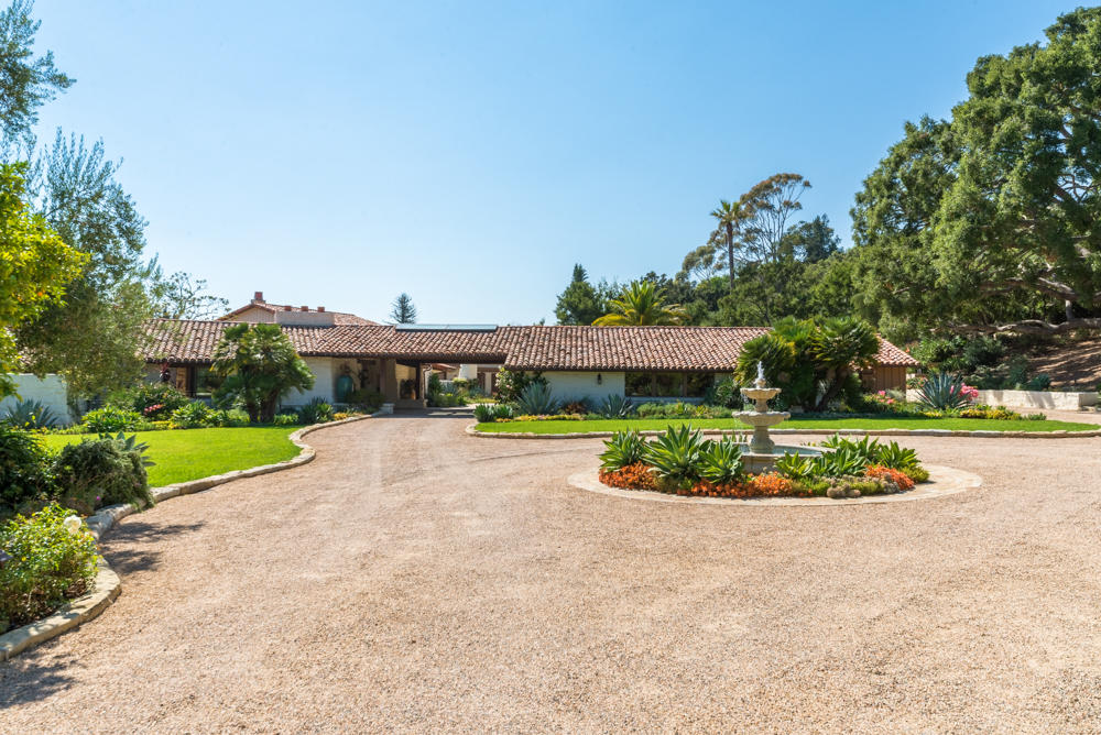 881 San Ysidro Lane Montecito, CA 93108 - Photo 5 of 78 a view of a house with a yard and potted plants