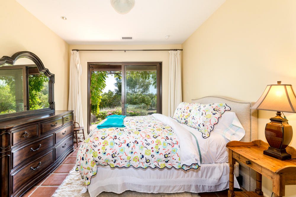 881 San Ysidro Lane Montecito, CA 93108 - Photo 52 of 78 a bedroom with a bed and a flat tv screen on dresser
