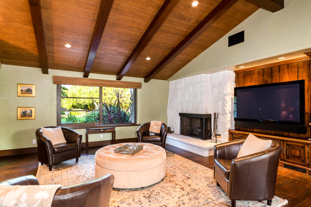 881 San Ysidro Lane Montecito, CA 93108 - Photo 71 of 78 a living room with furniture a fireplace and a flat screen tv