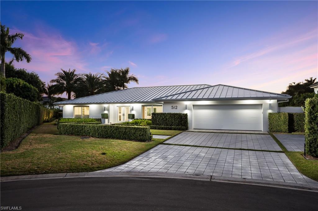 512 Neapolitan Lane Naples, FL 34103 - Photo 1 of 35 a front view of a house with yard