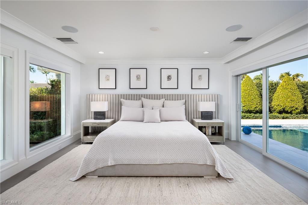 512 Neapolitan Lane Naples, FL 34103 - Photo 14 of 35 a bedroom with a large bed and a large window