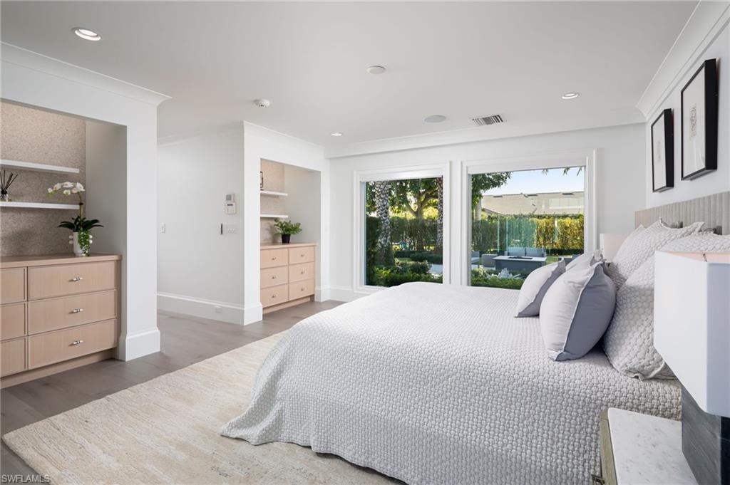 512 Neapolitan Lane Naples, FL 34103 - Photo 15 of 35 a bedroom with a bed and a dresser