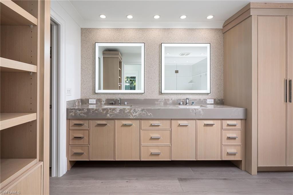 512 Neapolitan Lane Naples, FL 34103 - Photo 17 of 35 a bathroom with a granite countertop double vanity sink and a mirror