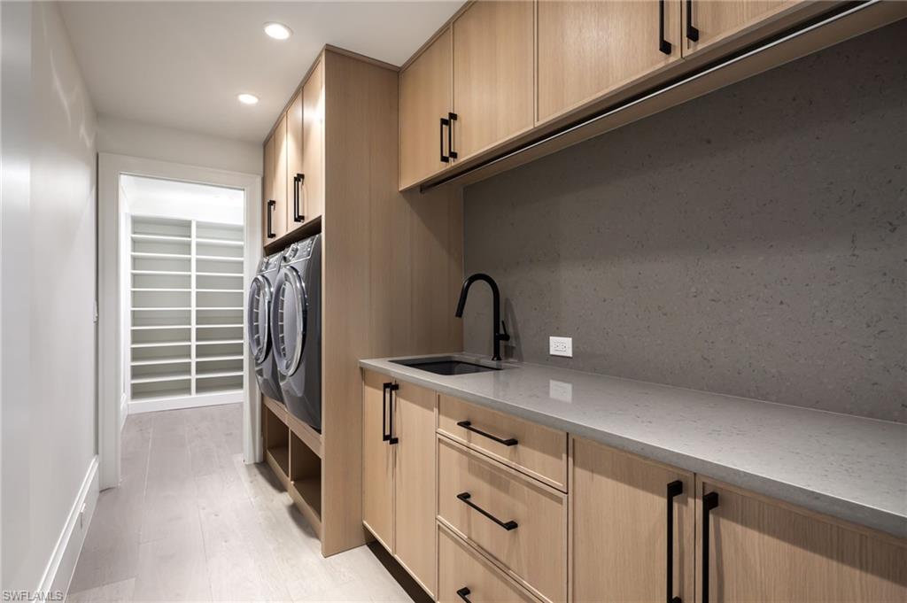 512 Neapolitan Lane Naples, FL 34103 - Photo 24 of 35 a kitchen with a refrigerator and cabinets