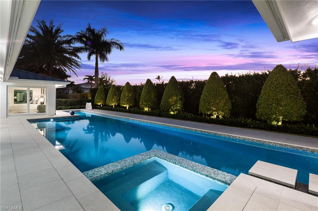 512 Neapolitan Lane Naples, FL 34103 - Photo 28 of 35 a view of a swimming pool with a patio