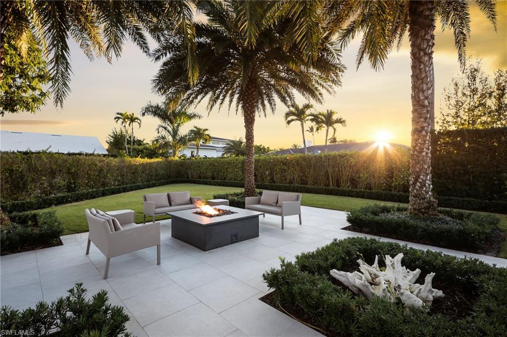 512 Neapolitan Lane Naples, FL 34103 - Photo 3 of 35 a backyard of a house with outdoor seating
