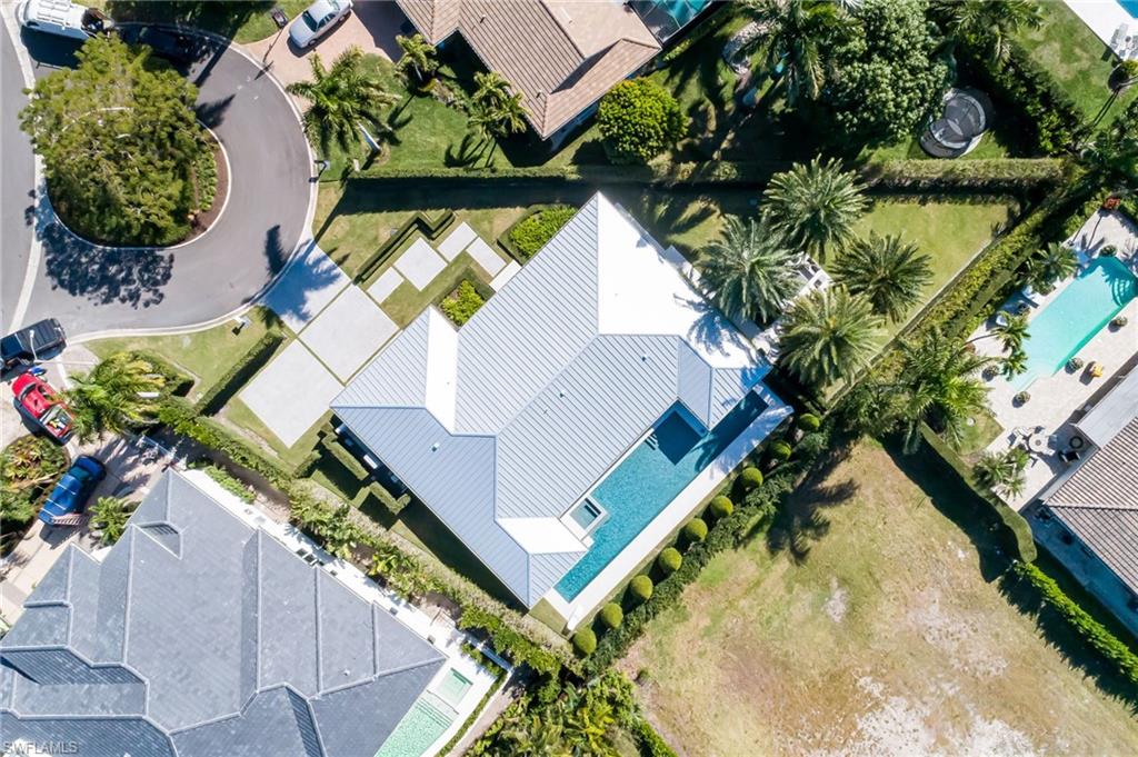 512 Neapolitan Lane Naples, FL 34103 - Photo 31 of 35 an aerial view of a house with a yard and potted plants