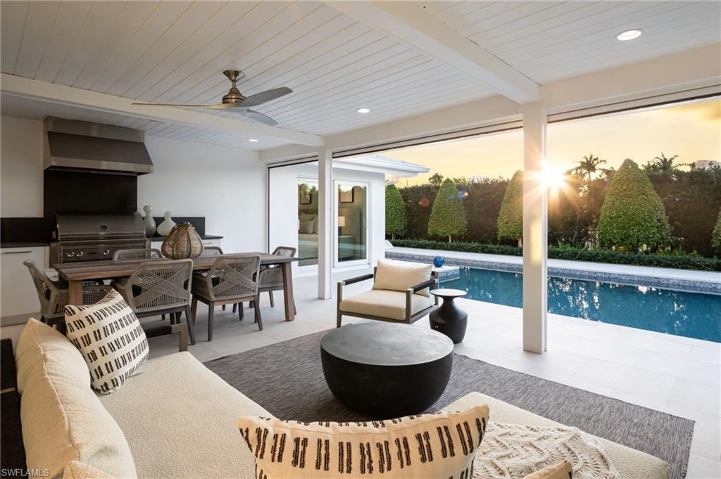 512 Neapolitan Lane Naples, FL 34103 - Photo 4 of 35 a living room with furniture and a large window