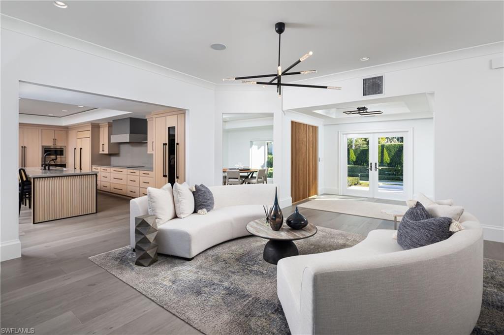 512 Neapolitan Lane Naples, FL 34103 - Photo 7 of 35 a living room with furniture and window