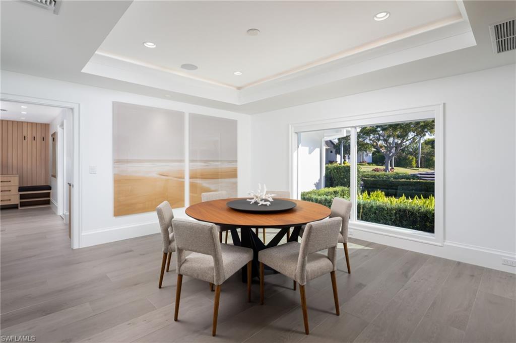 512 Neapolitan Lane Naples, FL 34103 - Photo 8 of 35 a dining room with furniture and wooden floor