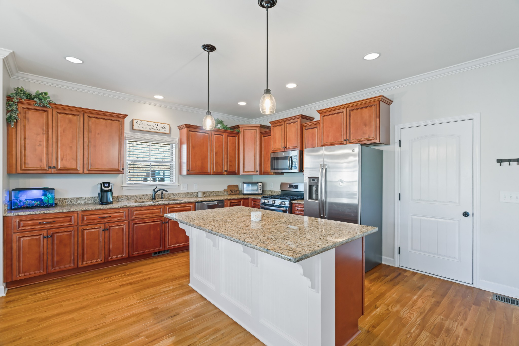 1003 Claymill Drive Spring Hill, TN 37174 - Photo 23 of 62 a kitchen with stainless steel appliances granite countertop a sink a stove and a wooden floors