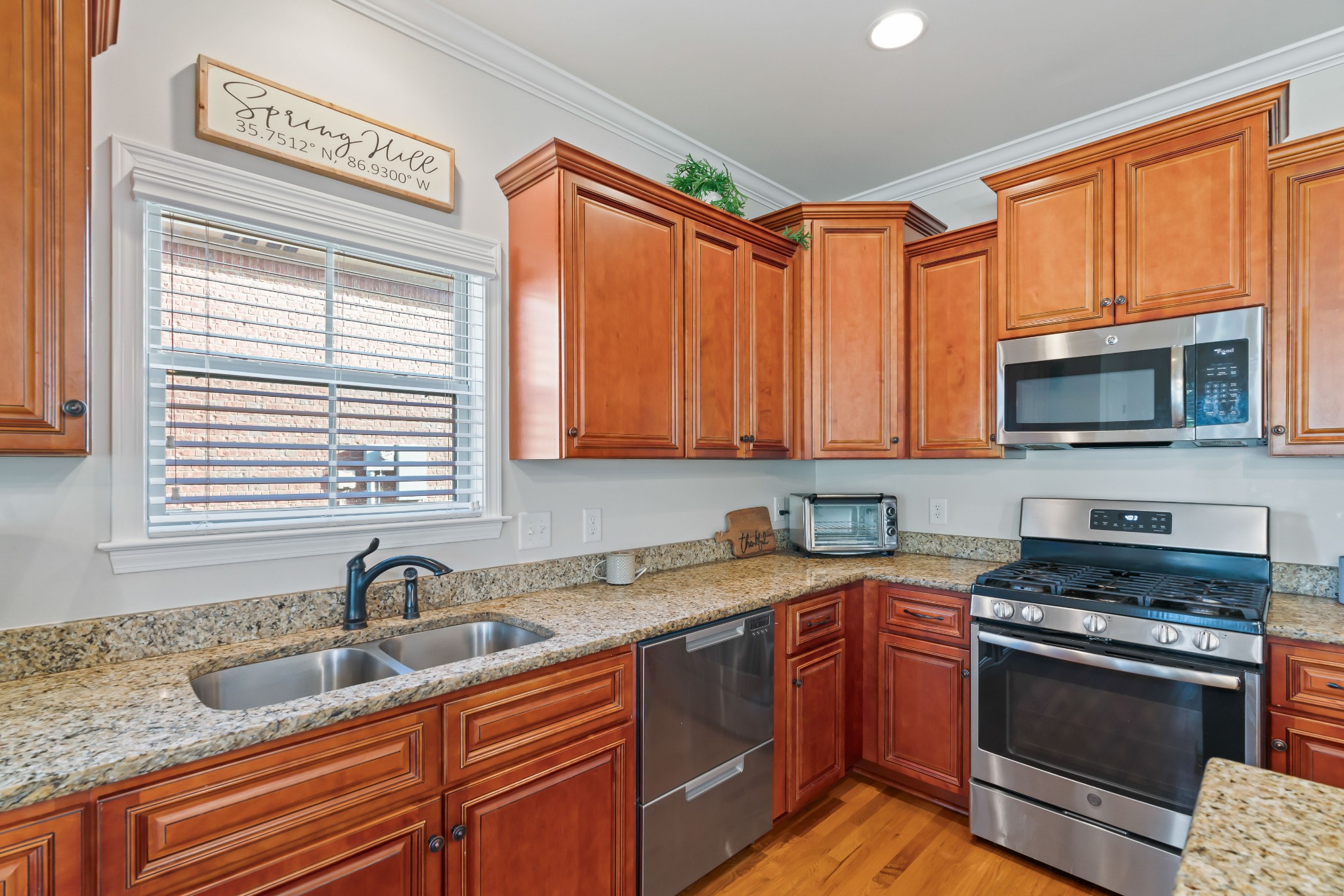 1003 Claymill Drive Spring Hill, TN 37174 - Photo 25 of 62 a kitchen with stainless steel appliances granite countertop a sink stove and microwave