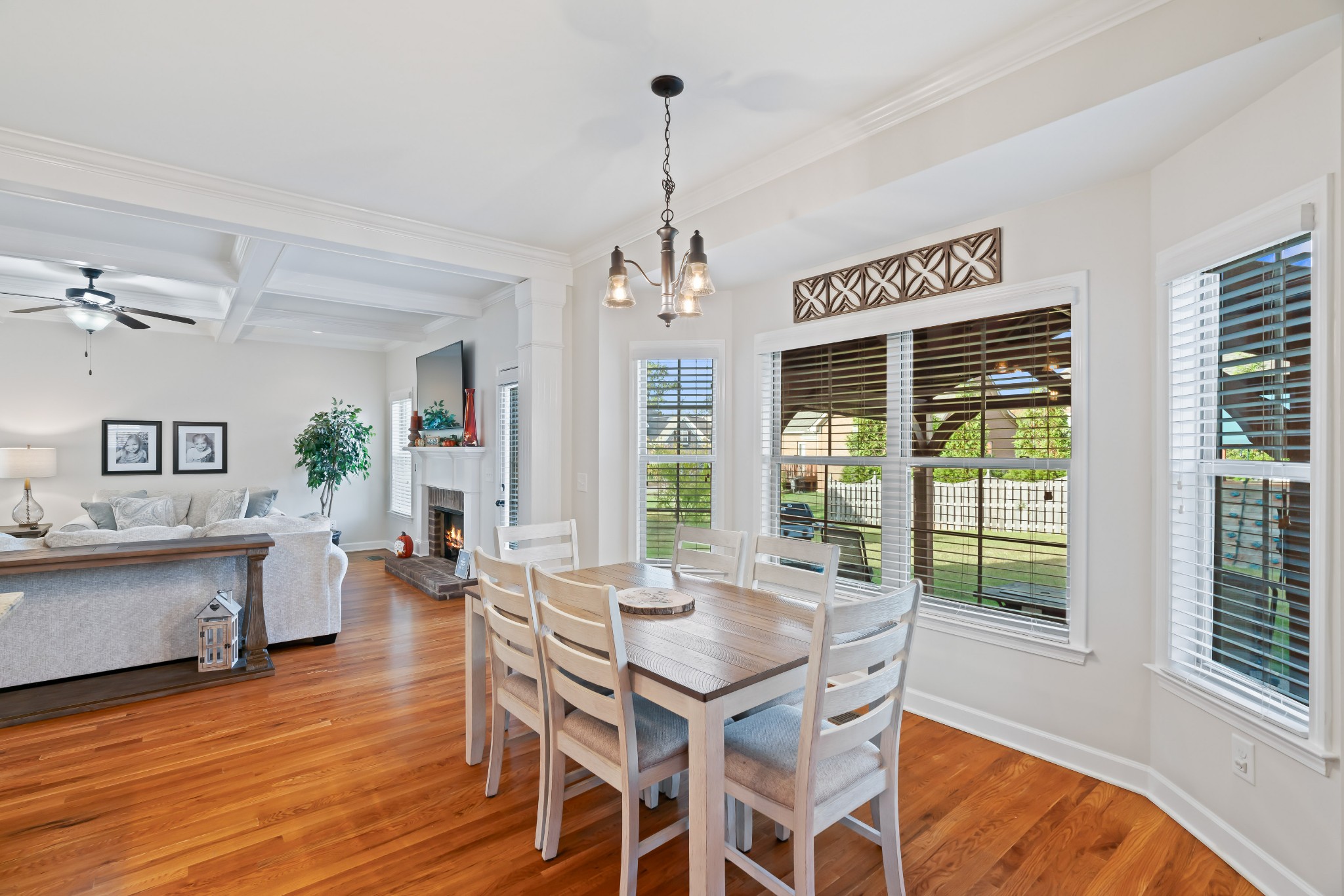 1003 Claymill Drive Spring Hill, TN 37174 - Photo 29 of 62 a dining room with wooden floor a chandelier a glass table and chairs