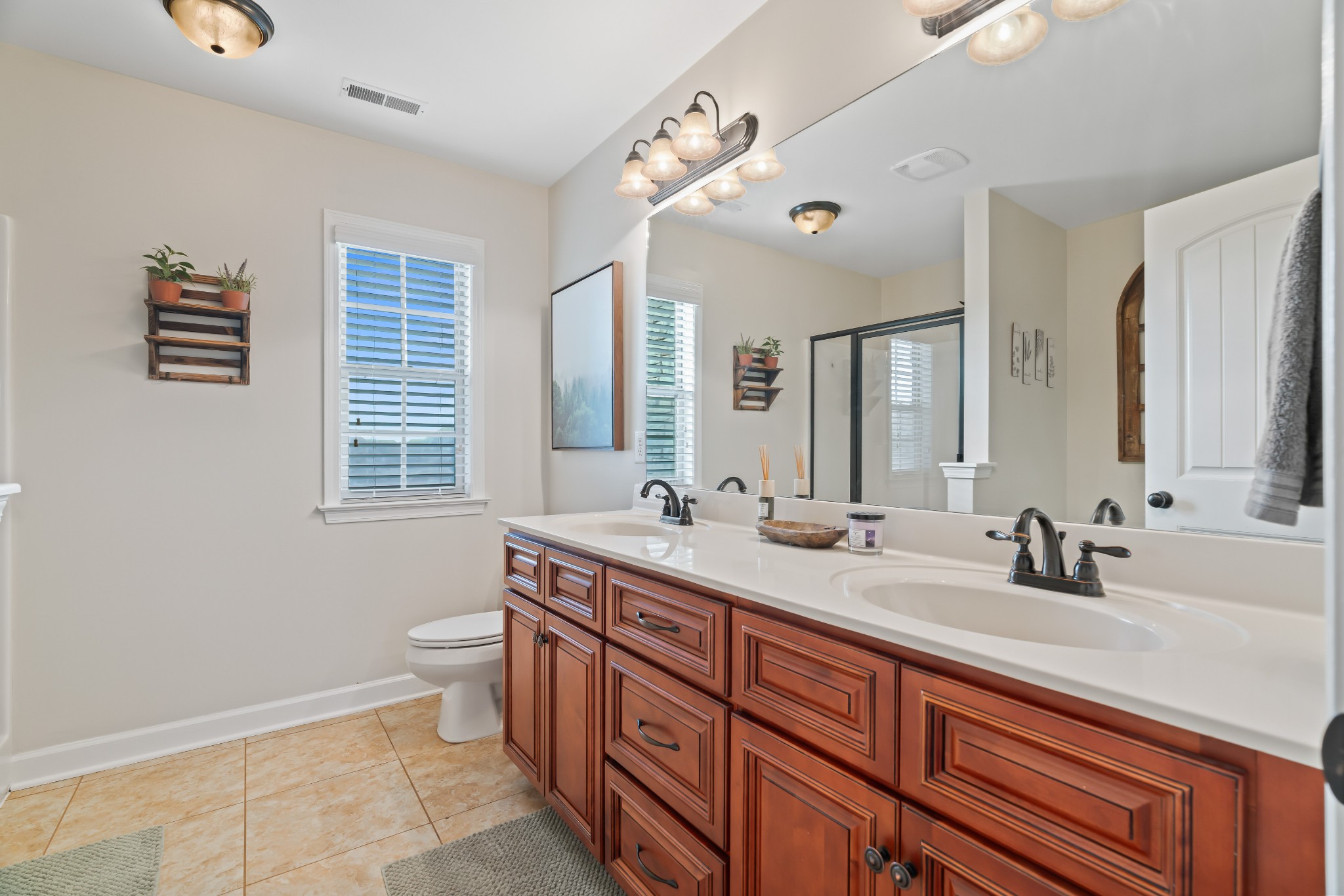 1003 Claymill Drive Spring Hill, TN 37174 - Photo 36 of 62 a spacious bathroom with double vanity a mirror a bathtub and a sink