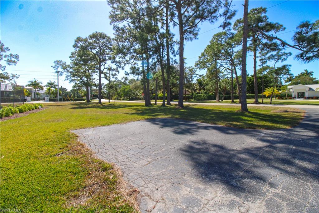 516 Gordonia Road Naples, FL 34108 - Photo 12 of 50 a view of a park with swings and slides