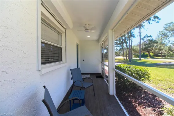 a view of a porch with furniture and garden