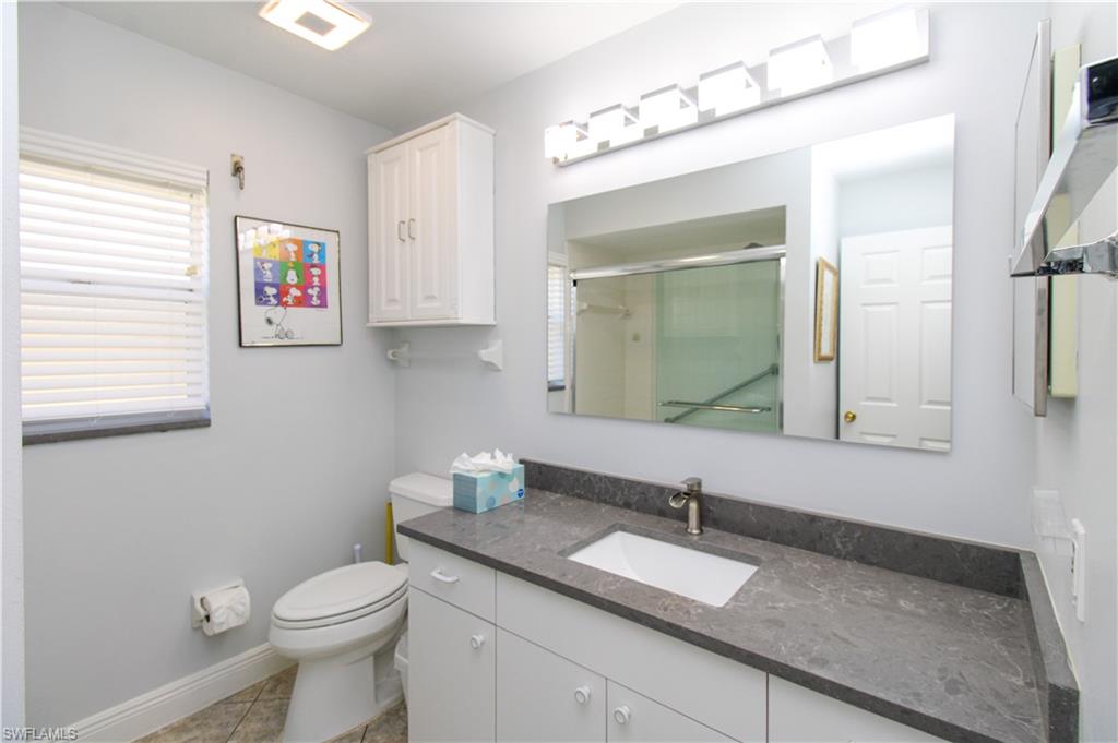 516 Gordonia Road Naples, FL 34108 - Photo 24 of 50 a bathroom with a granite countertop sink and a mirror