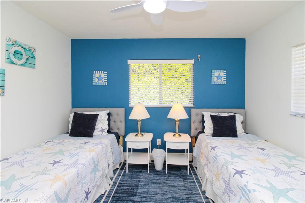 516 Gordonia Road Naples, FL 34108 - Photo 25 of 50 a bedroom with a bed and a lamp