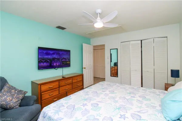 a bedroom with a bed and a television