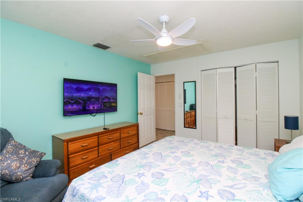 516 Gordonia Road Naples, FL 34108 - Photo 29 of 50 a bedroom with a bed and a television