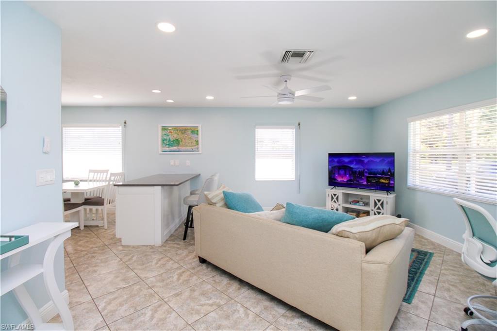 516 Gordonia Road Naples, FL 34108 - Photo 33 of 50 a living room with furniture and a flat screen tv