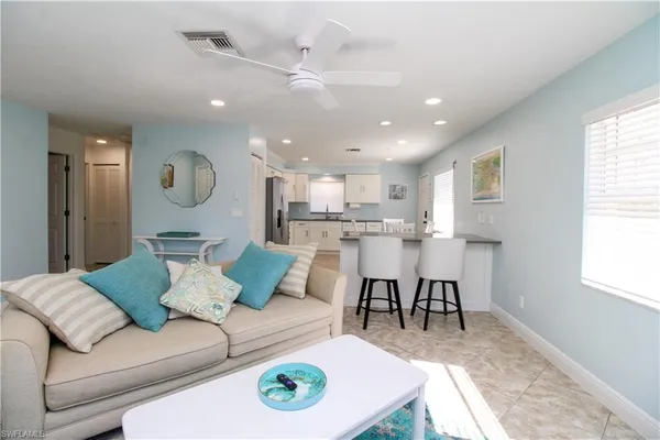 a living room with furniture and kitchen view