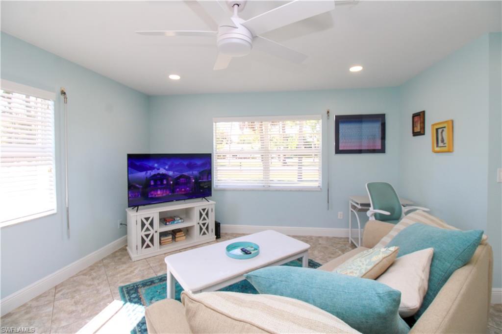 516 Gordonia Road Naples, FL 34108 - Photo 37 of 50 a living room with furniture a flat screen tv and a window