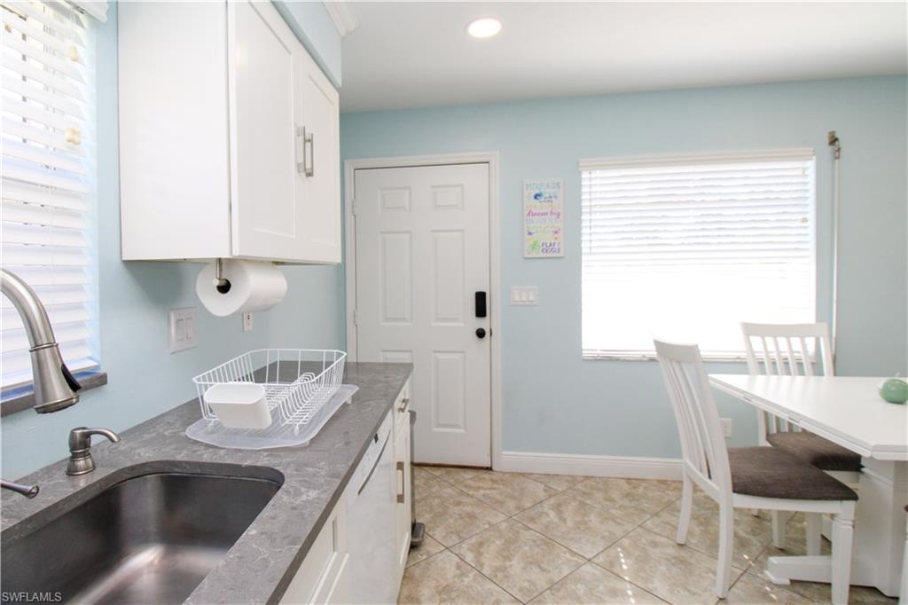516 Gordonia Road Naples, FL 34108 - Photo 42 of 50 a kitchen view with granite countertop a sink and a stove top oven