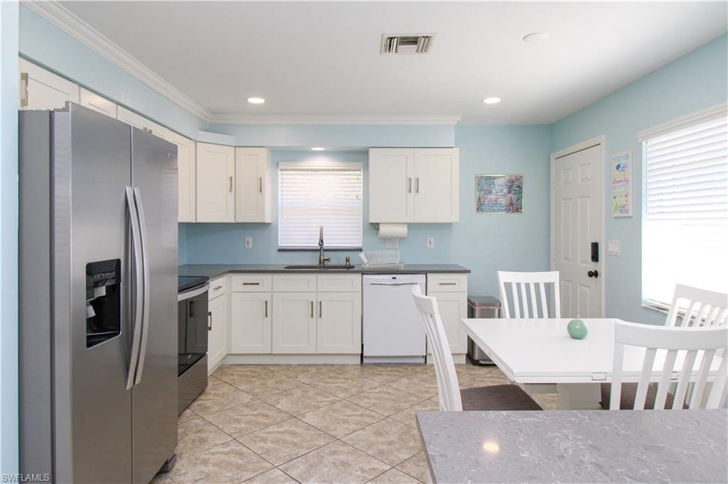 516 Gordonia Road Naples, FL 34108 - Photo 44 of 50 a kitchen with stainless steel appliances granite countertop a refrigerator and a stove top oven