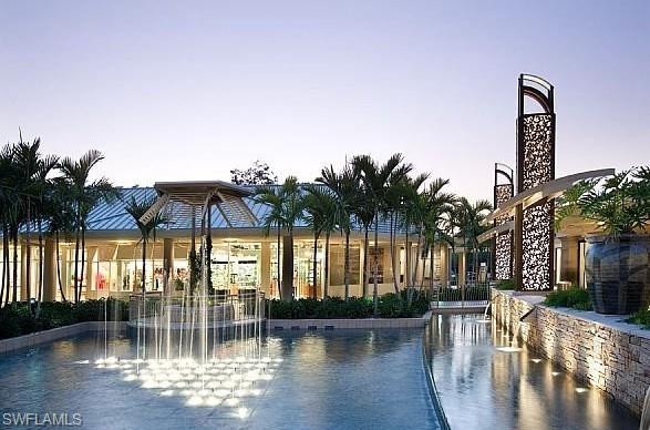 516 Gordonia Road Naples, FL 34108 - Photo 48 of 50 a view of swimming pool with outdoor seating and plants