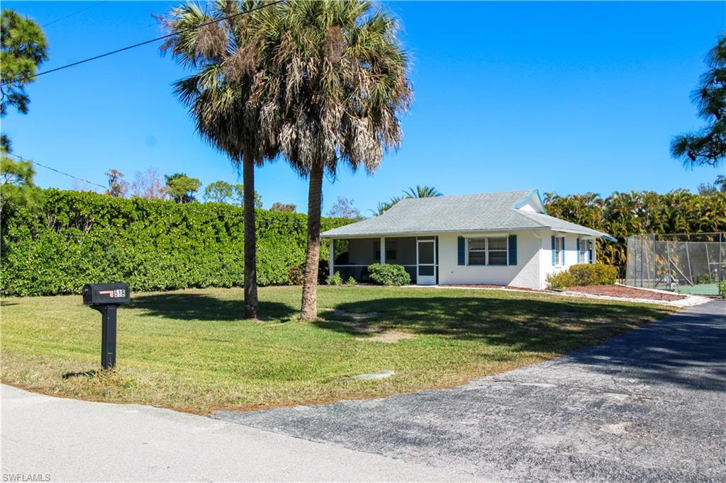516 Gordonia Road Naples, FL 34108 - Photo 6 of 50 a front view of a house with garden