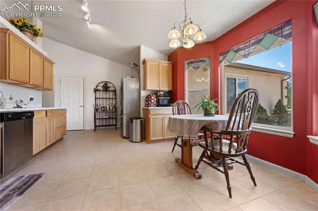 a view of a dining room with furniture and a chandelier