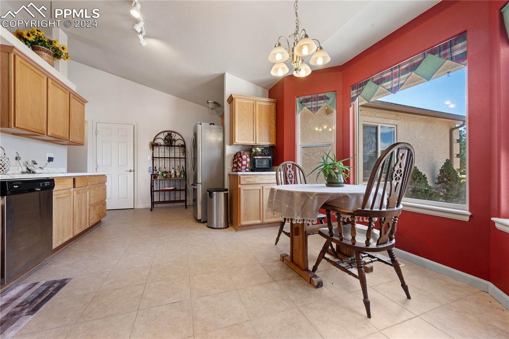 17950 Cumbres Road Peyton, CO 80831 - Photo 11 of 21 a view of a dining room with furniture and a chandelier