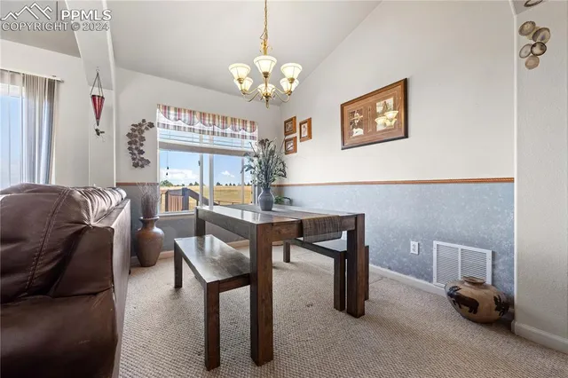 a living room with furniture a table and a chandelier